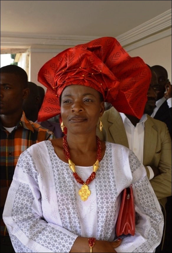 Head-wear-the scarf specially worn in this way is typical of the Yoruba people